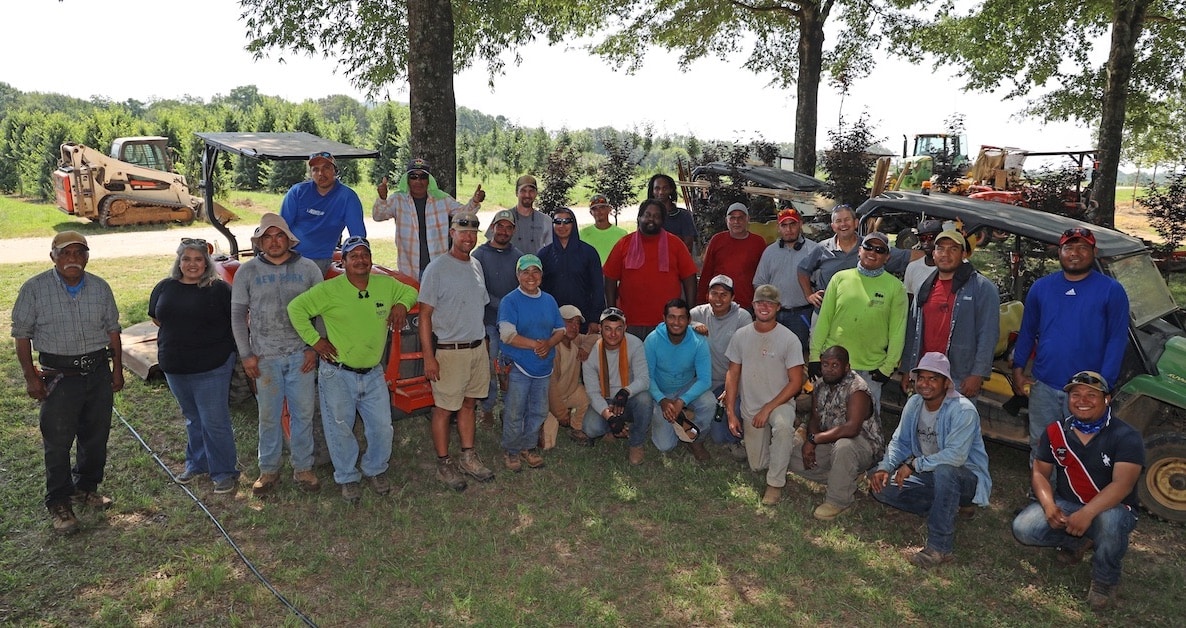 a group of people standing in front of a crowd posing for the camera